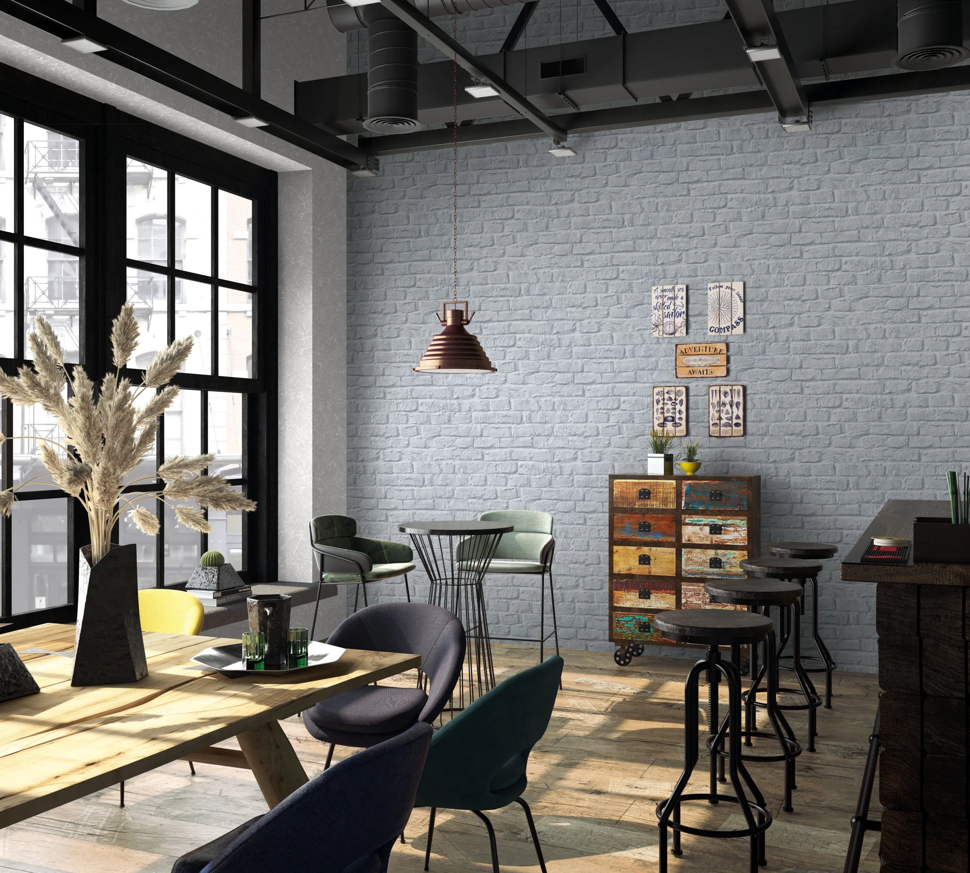 Marburg Loft Superior 34167 Gray brick-effect wallpaper covers a large wall in an industrial-style cafe with bar stools, a dining table and chairs, a pendant light, large windows, and a colorful chest of drawers.