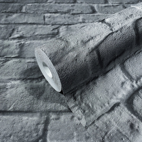 Marburg Loft Superior 34170 Close-up of a wallpaper roll with a dark textured faux brick design, partially unrolled on the same pattern.