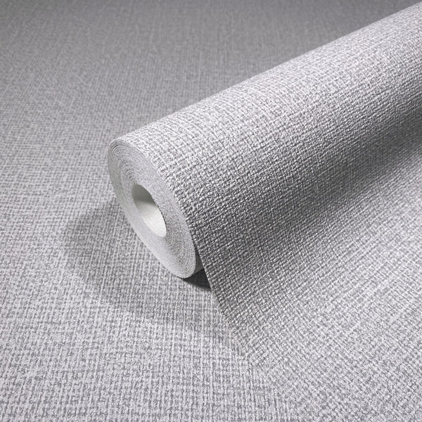 Marburg Loft Superior 34173 A gray wallpaper roll with a subtle crosshatch texture, shown partially unrolled on the same patterned surface.