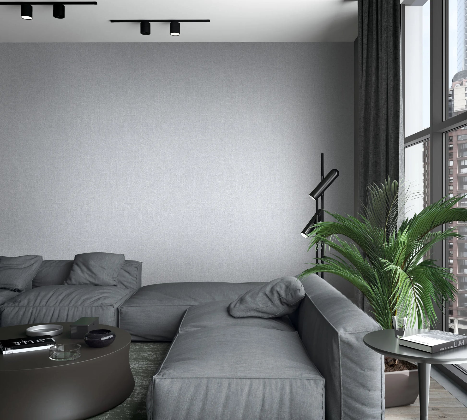 Marburg Loft Superior 34173 Light gray textured wallpaper on a feature wall behind a modular gray sofa in a modern living room, with a black floor lamp, potted palm, round coffee table, side table, curtains, and a large window.