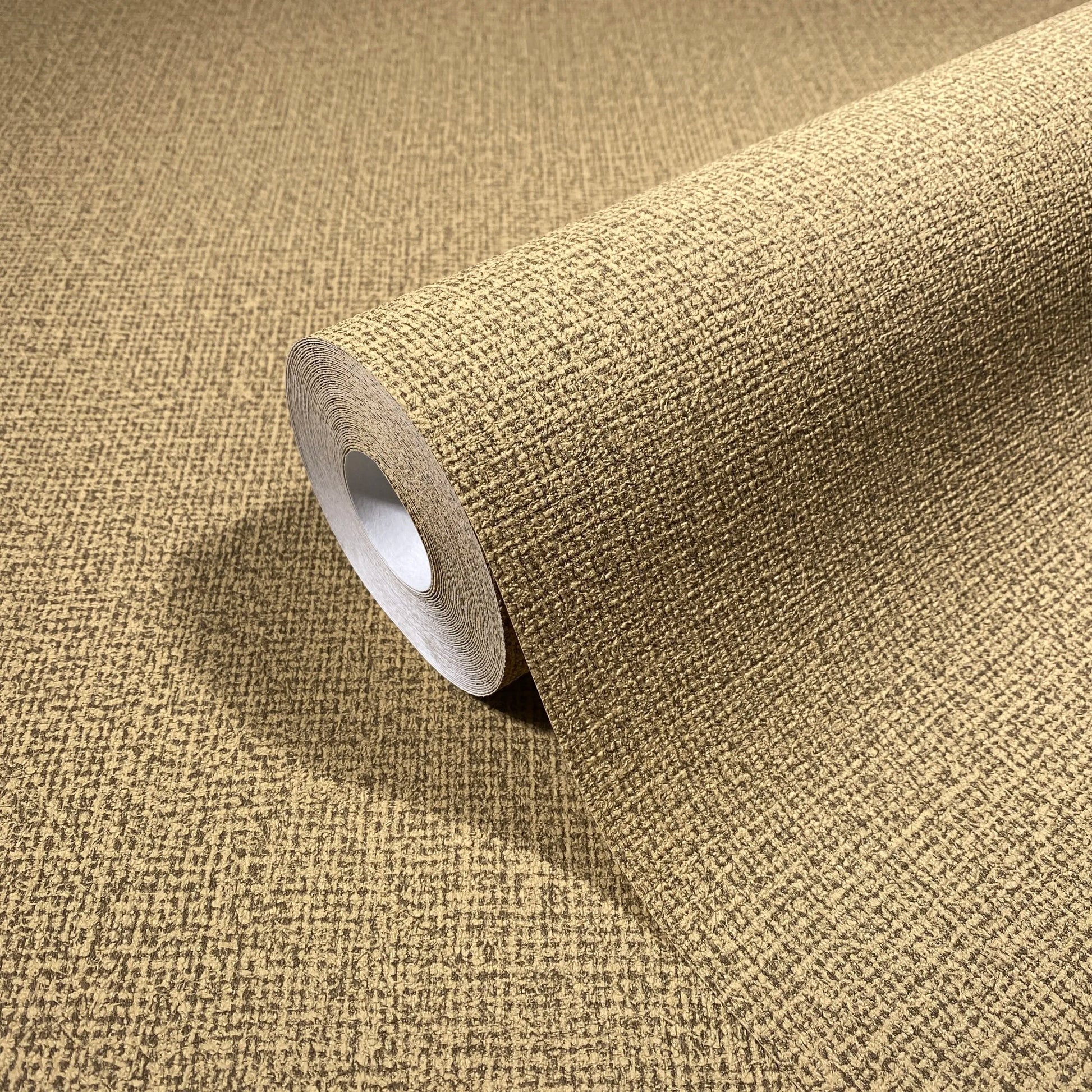 Marburg Loft Superior 34178 Brown textured crosshatch wallpaper roll partially unrolled on a matching surface, close-up product view.