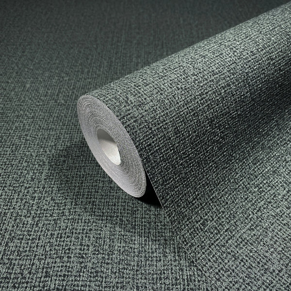Marburg Loft Superior 34180 Close-up of a dark green textured wallpaper roll resting on matching unrolled wallpaper, showing a fine crosshatch pattern.