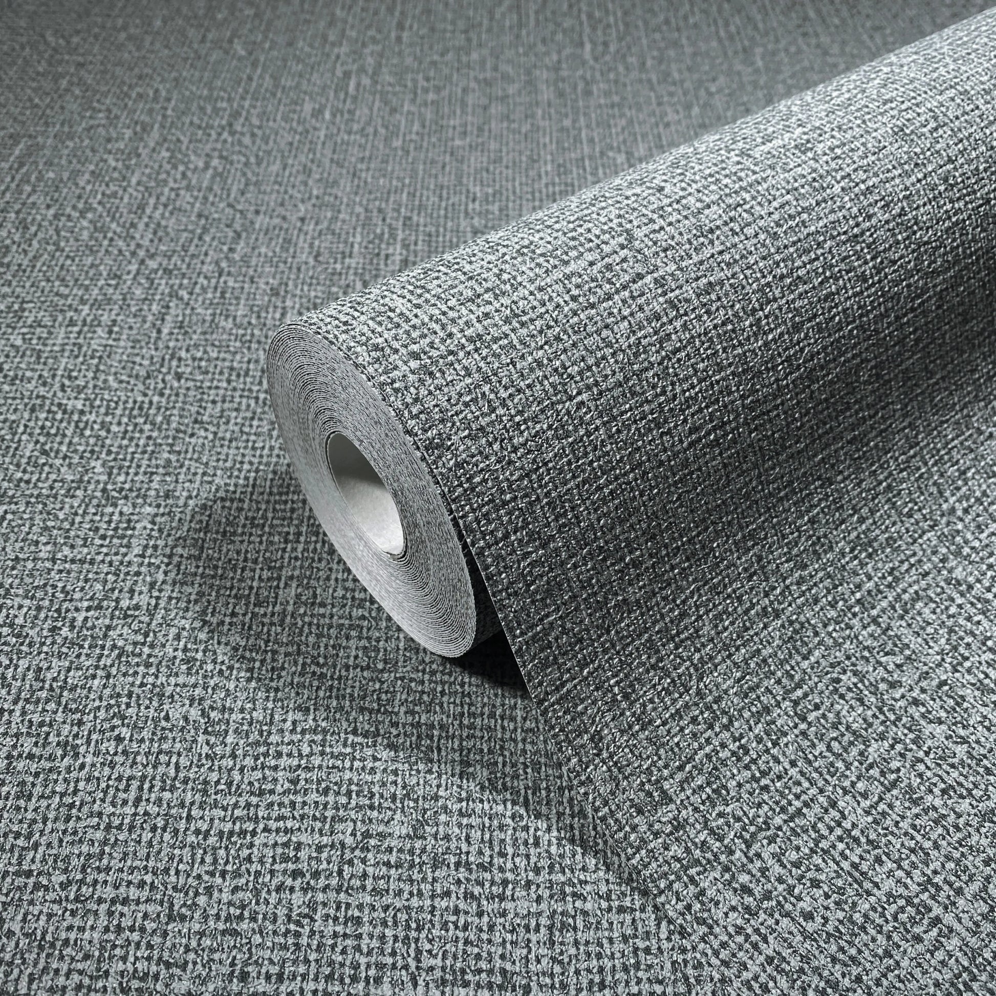 Marburg Loft Superior 34181 Wallpaper roll partially unrolled on a matching surface, showing a fine textured crosshatch pattern in gray.