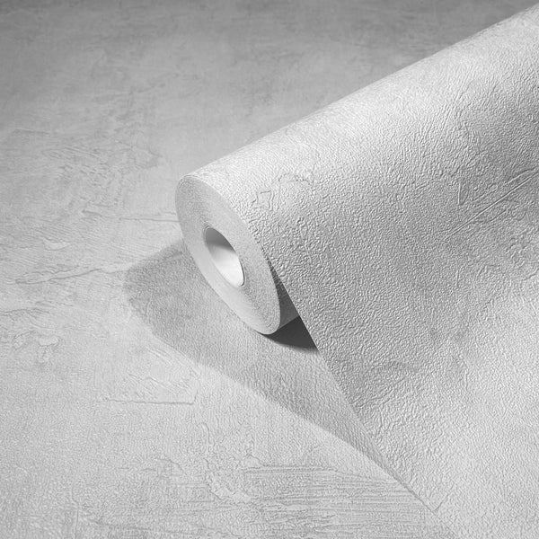 Marburg Loft Superior 34184 A roll of light textured wallpaper in white resting on a matching unrolled section, showing a subtle plaster-like emboss.