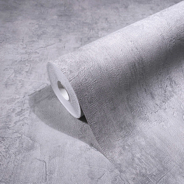Marburg Loft Superior 34187 Gray textured plaster-effect wallpaper roll resting on a matching unrolled sheet, showing the irregular stucco pattern.