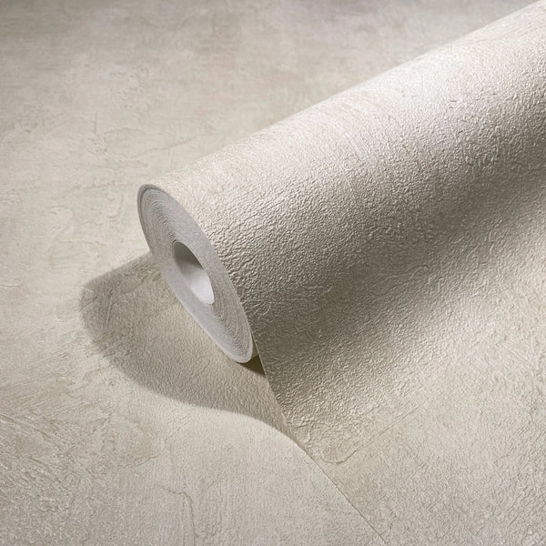 Marburg Loft Superior 34191 A light beige wallpaper roll with a subtle plaster-like texture unrolling across a matching surface.
