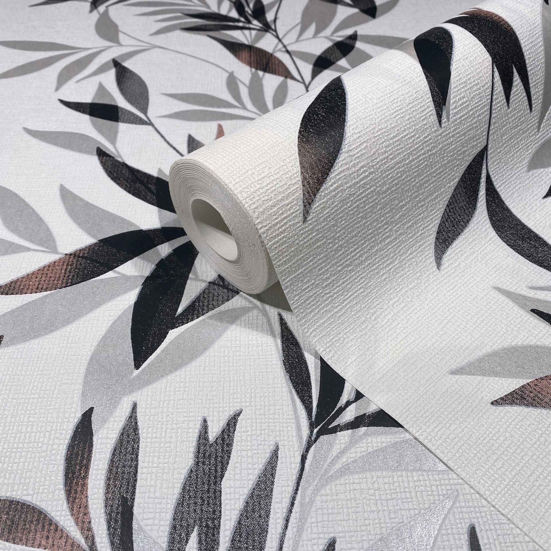 Marburg Mona 82458 Wallpaper roll on matching surface showing a black and gray leafy pattern on a white textured background.
