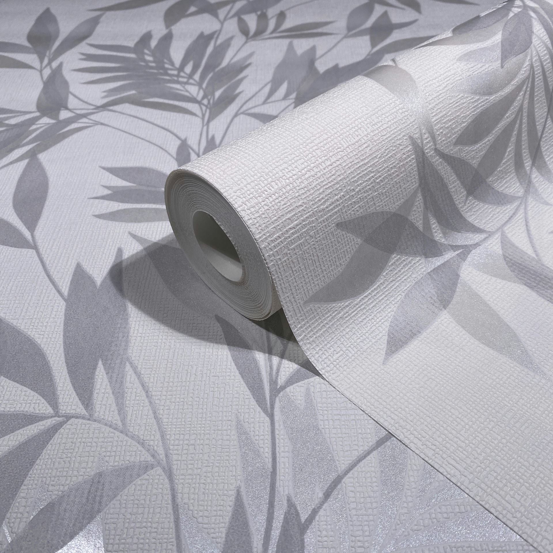 Marburg Mona 82460 Wallpaper roll on matching sheet showing a white textured surface with gray leaf silhouettes.