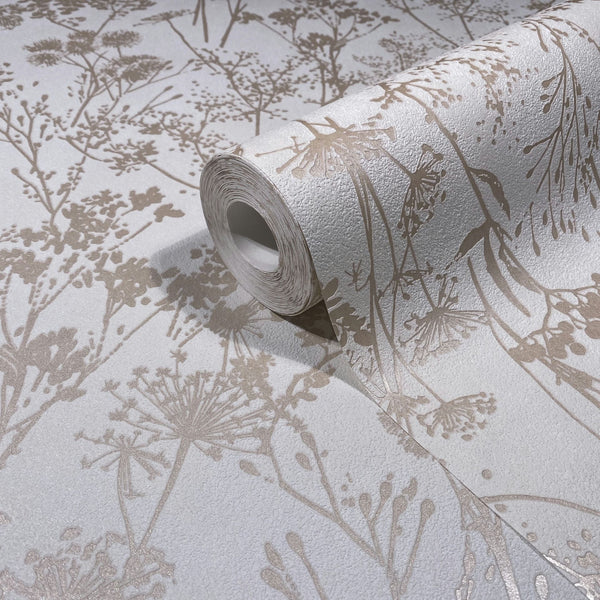Marburg Mona 82463 Close-up of a wallpaper roll resting on matching wallpaper, showing beige botanical silhouettes of wildflowers on a textured white background.