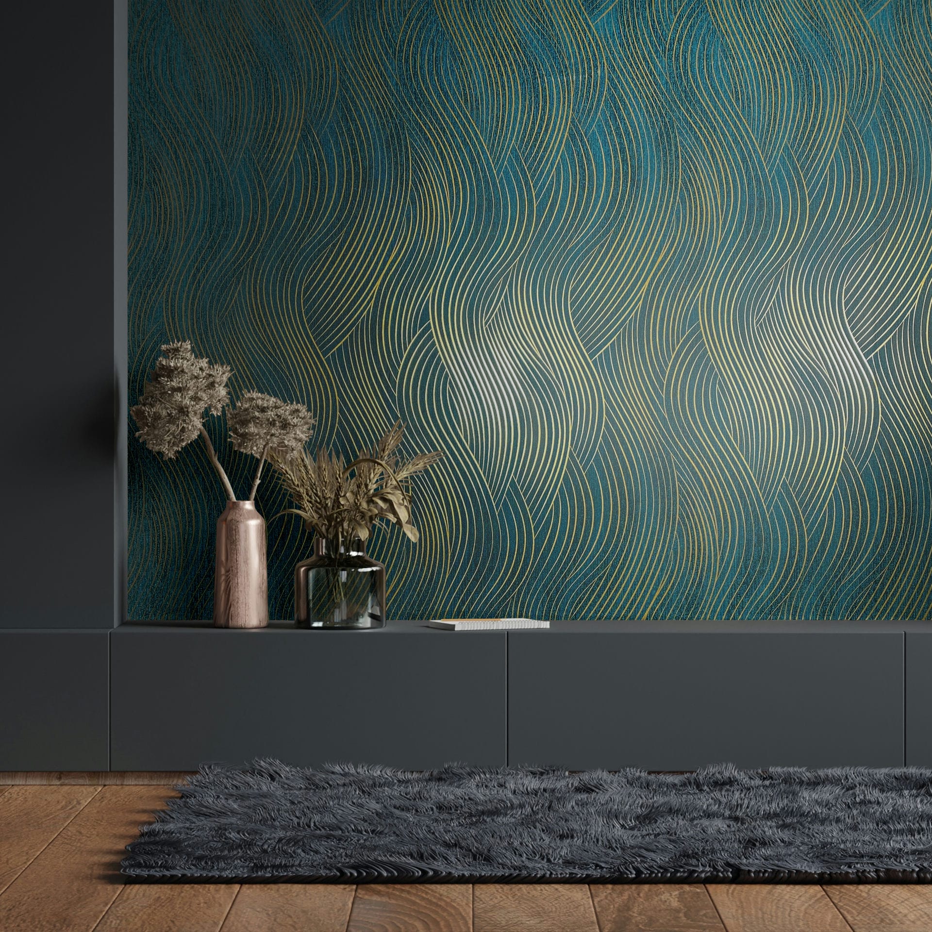 Marburg Mona 82477 Green wallpaper with flowing gold curved lines behind a low dark console. Dried stems sit in a metal vase and a glass vase on the console, with a shag rug and wood floor in front.