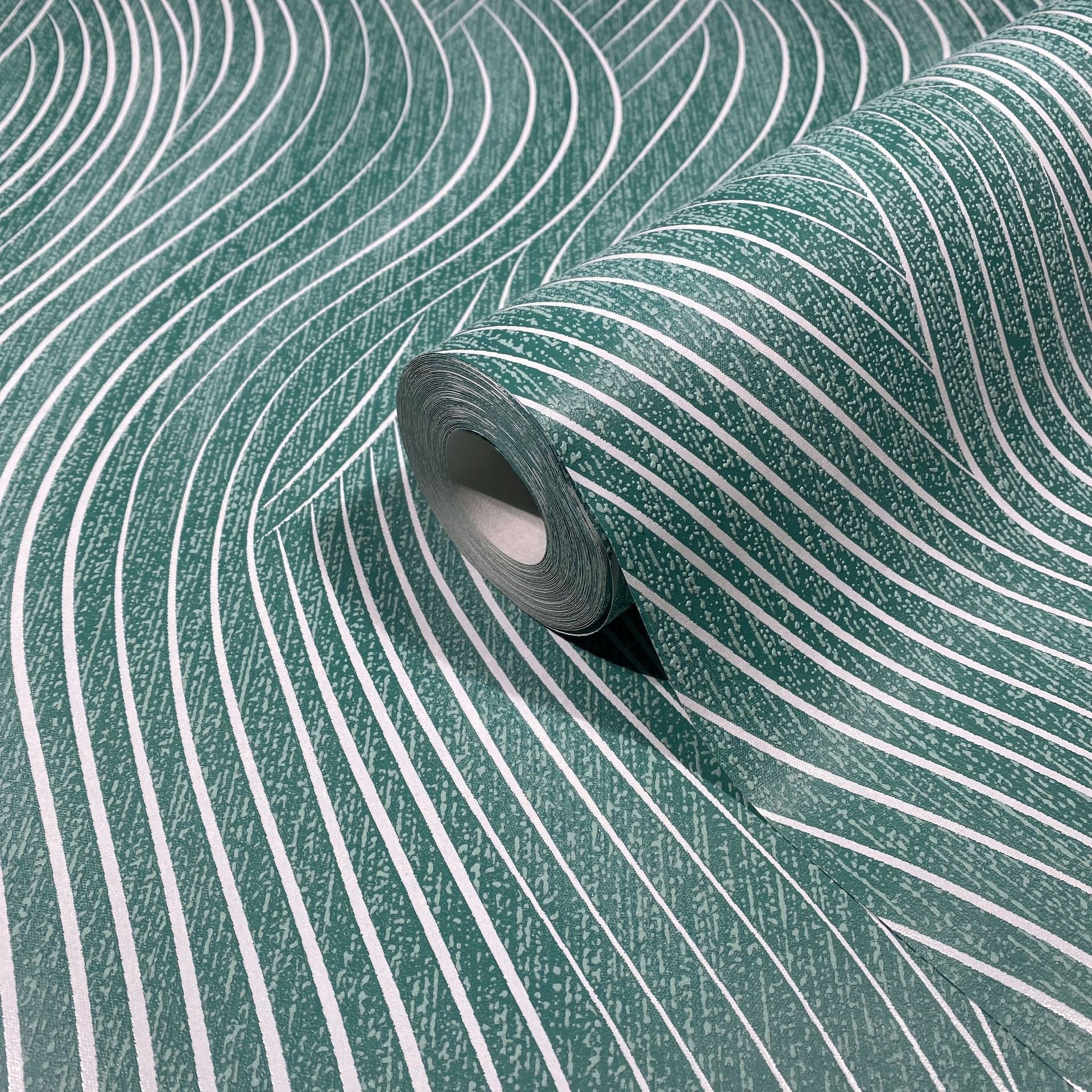 Marburg Mona 82478 Close-up product view of a wallpaper roll resting on matching sheet with flowing white wavy stripes over a green background.