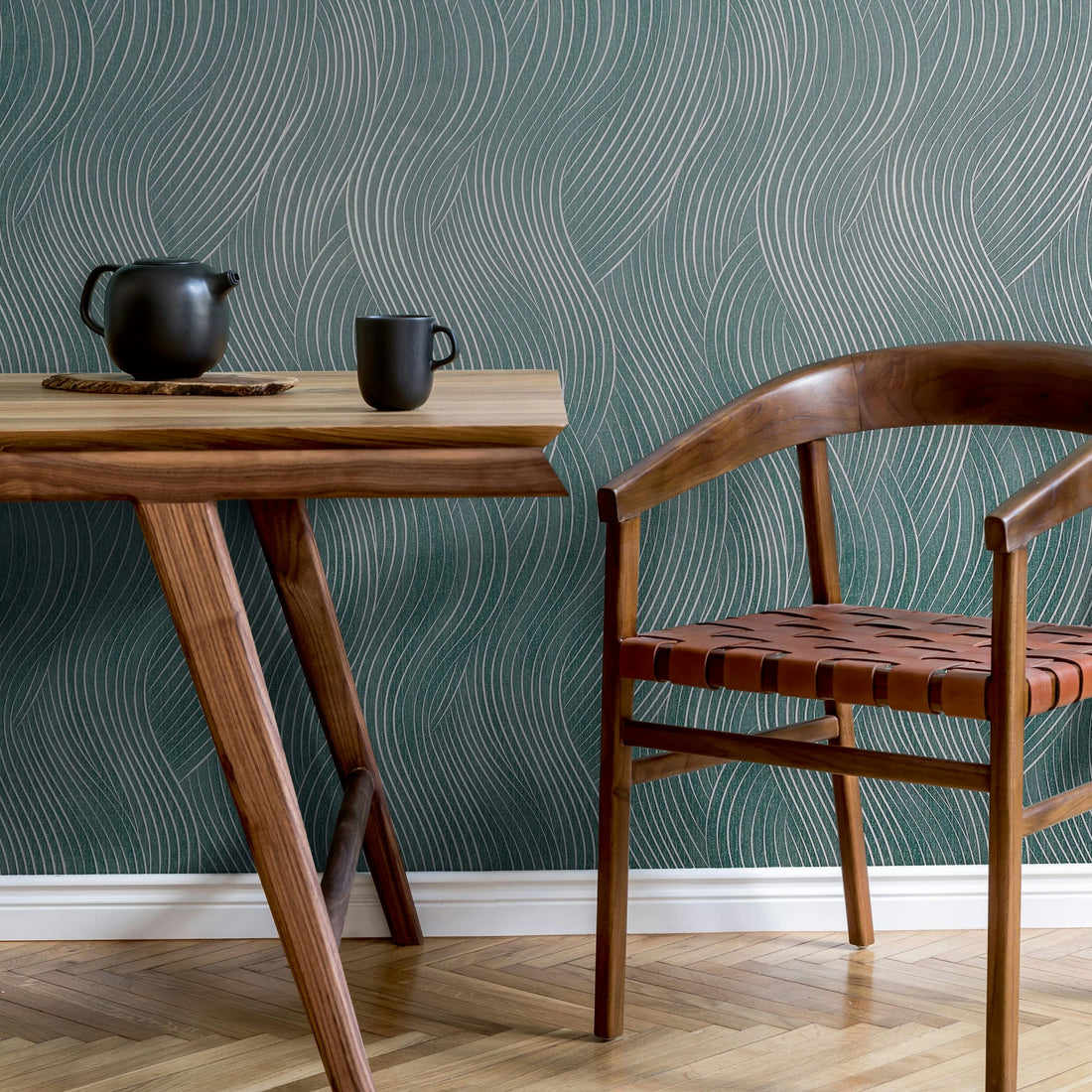 Marburg Mona 82478 wallpaper with teal-blue wavy geometric lines and subtle silver accents
