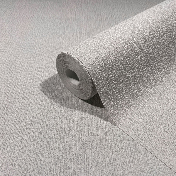 Marburg Mona 82479 Close-up of a light gray textured wallpaper roll resting on the same pattern surface, showing raised stippled texture and subtle vertical lines.