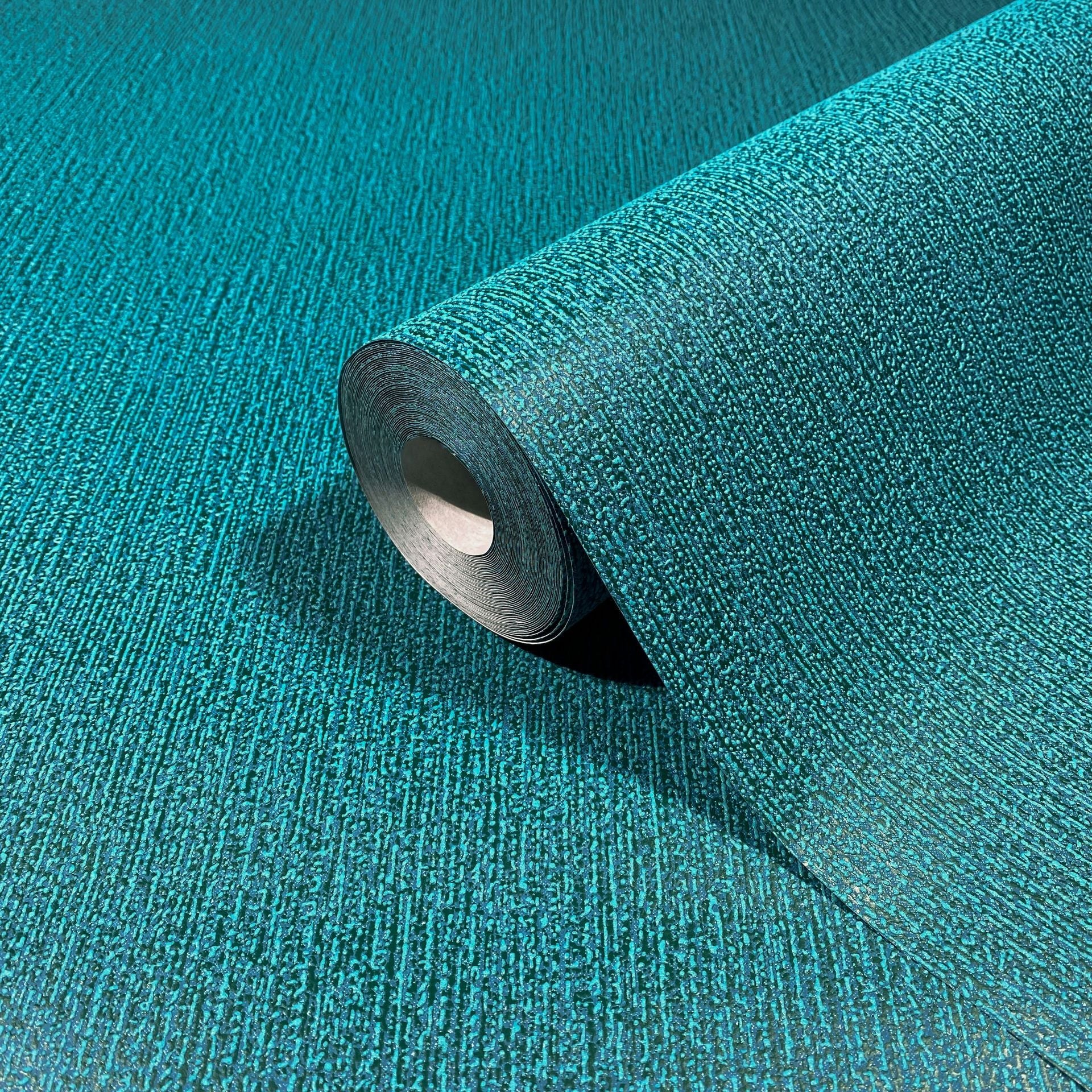 Marburg Mona 82482 Teal textured wallpaper roll with fine irregular vertical lines, shown resting on matching unrolled wallpaper.