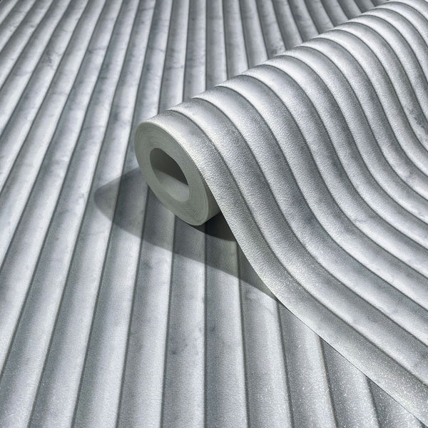 Marburg Mona 89005 A gray wallpaper roll with softly curved vertical ribs, shown resting on the same patterned wallpaper.