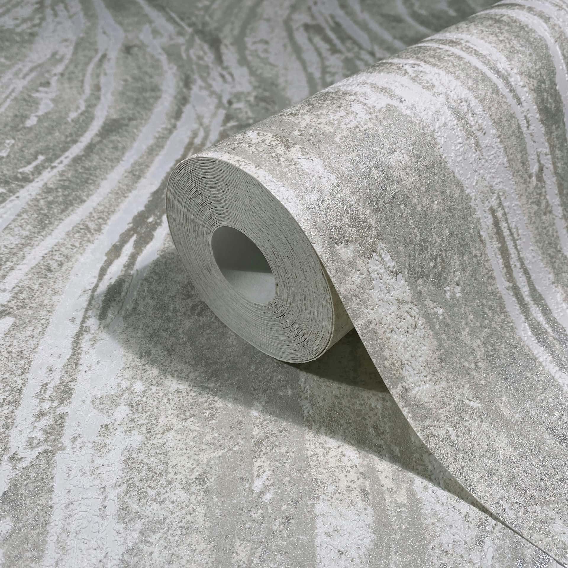 Marburg Naomi 82495 Partially unrolled wallpaper roll showing an abstract wavy beige and gray design on a matching surface.