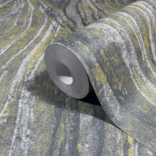 Marburg Naomi 82496 Angled close-up of a gray and yellow streaked wallpaper roll resting on the matching unrolled paper.