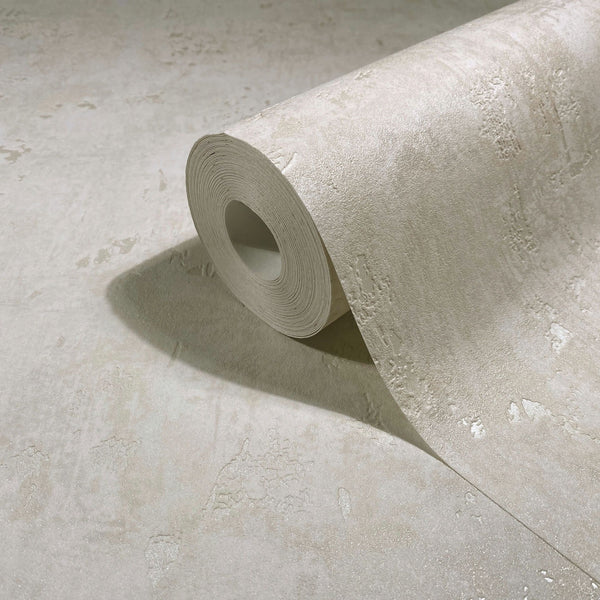 Marburg Naomi 82498 Close-up of a beige textured wallpaper roll with a subtle plaster-like pattern, partially unrolled on the same material.