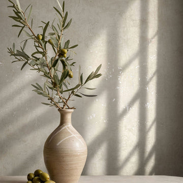 Marburg Naomi 82498 Light beige wallpaper with a subtle mottled plaster effect and faint distressed patches wallpaper shown in a styled detail.