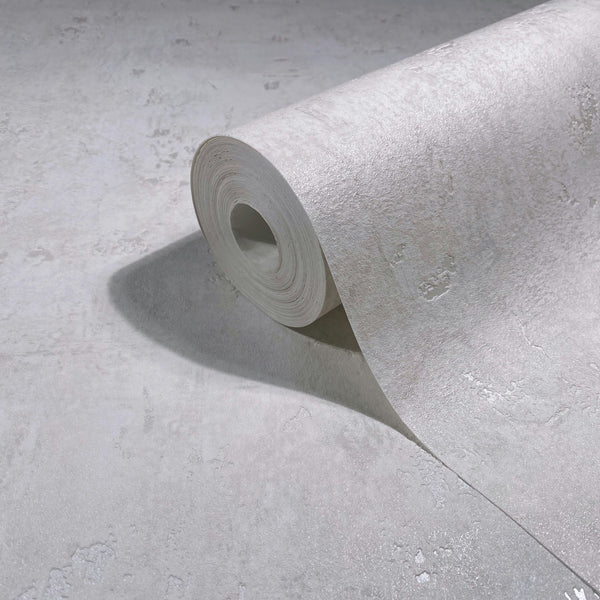 Marburg Naomi 82499 Close-up of a partially unrolled wallpaper roll showing a light neutral, gently mottled texture with a slight sheen.