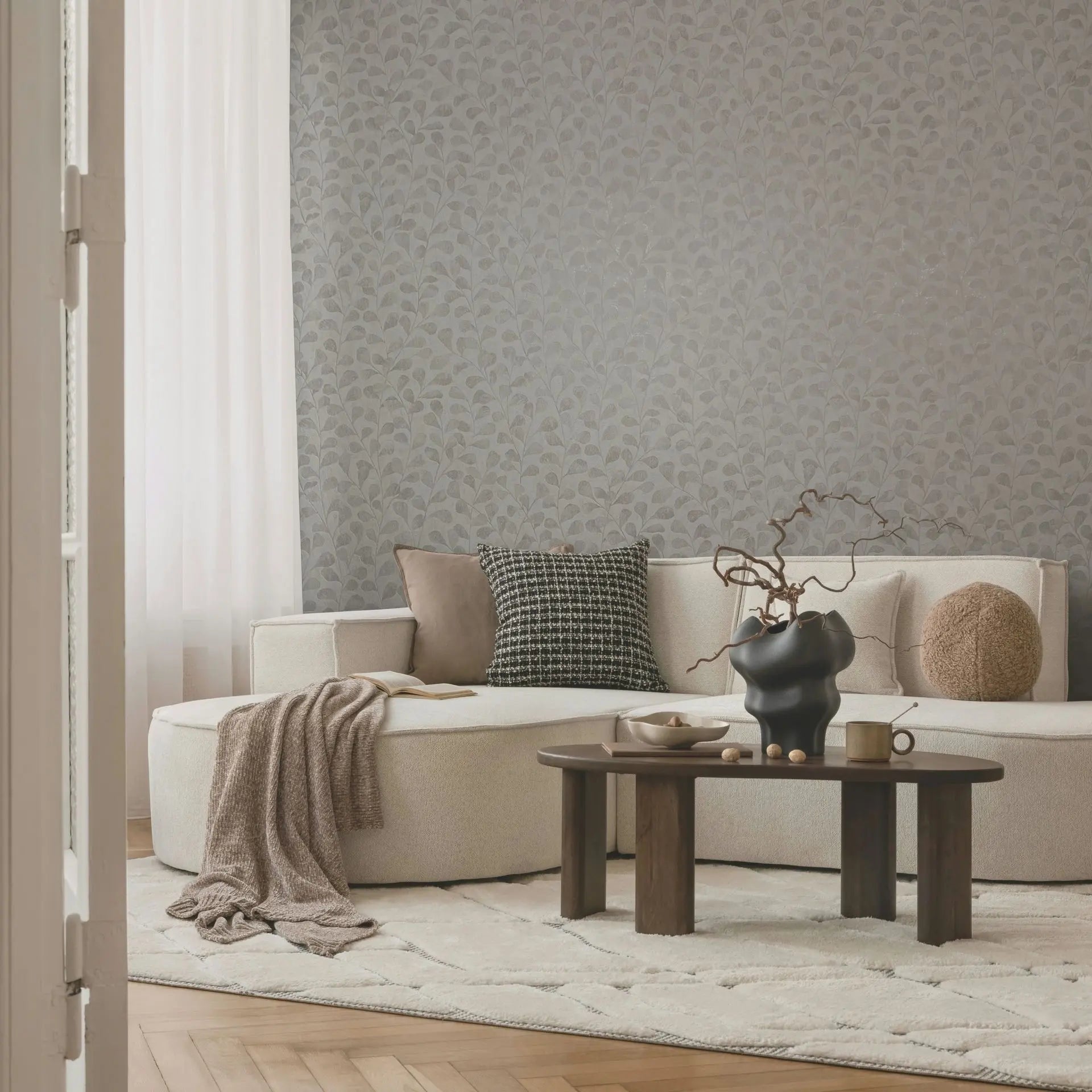 Marburg Naomi 82502 taupe leafy non-woven wallpaper with plaster-look background in a contemporary living room