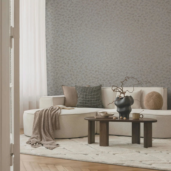 Marburg Naomi 82502 taupe leafy non-woven wallpaper with plaster-look background in a contemporary living room