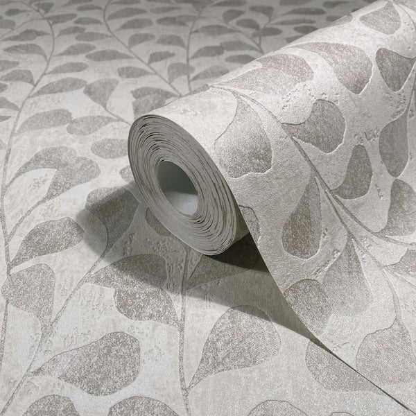 Marburg Naomi 82502 Wallpaper roll on a matching surface showing a large stylized leaf pattern in beige and gray.