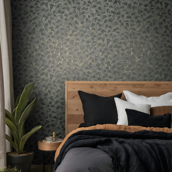 Marburg Naomi 82503 Dark gray wallpaper with a dense leafy vine motif and scattered gold-toned flecks wallpaper on a bedroom feature wall.