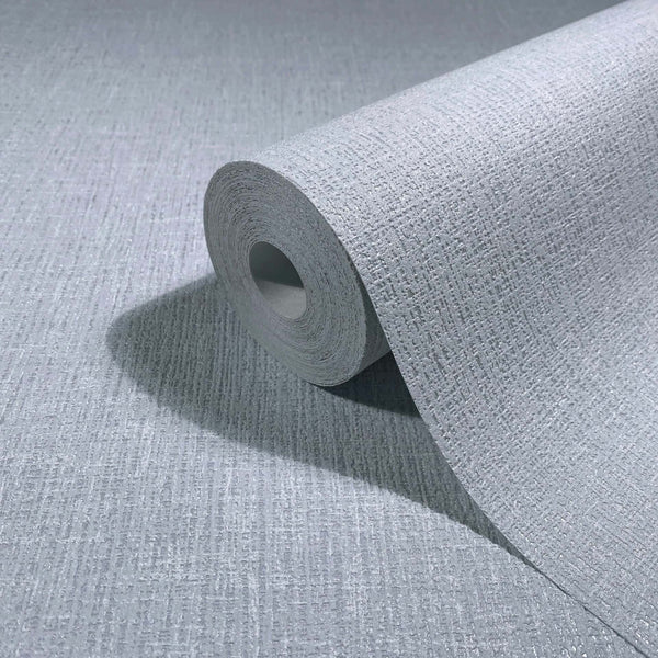 Marburg Naomi 82542 Close-up of a light blue textured crosshatch wallpaper roll, partially unrolled on the same surface.