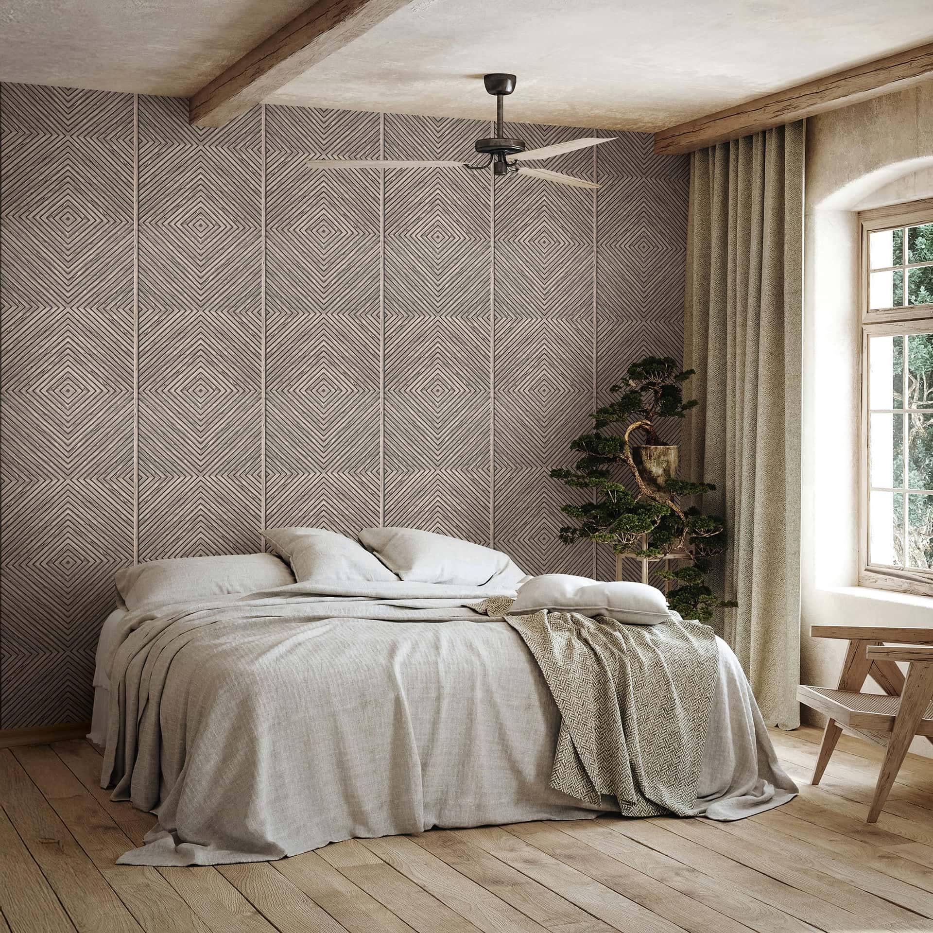 Marburg Naomi 89018 Bedroom scene with a neutral geometric diamond‑panel wallpaper behind a low bed, next to a window with curtains; a small potted tree, a wooden chair, and a ceiling fan are visible.