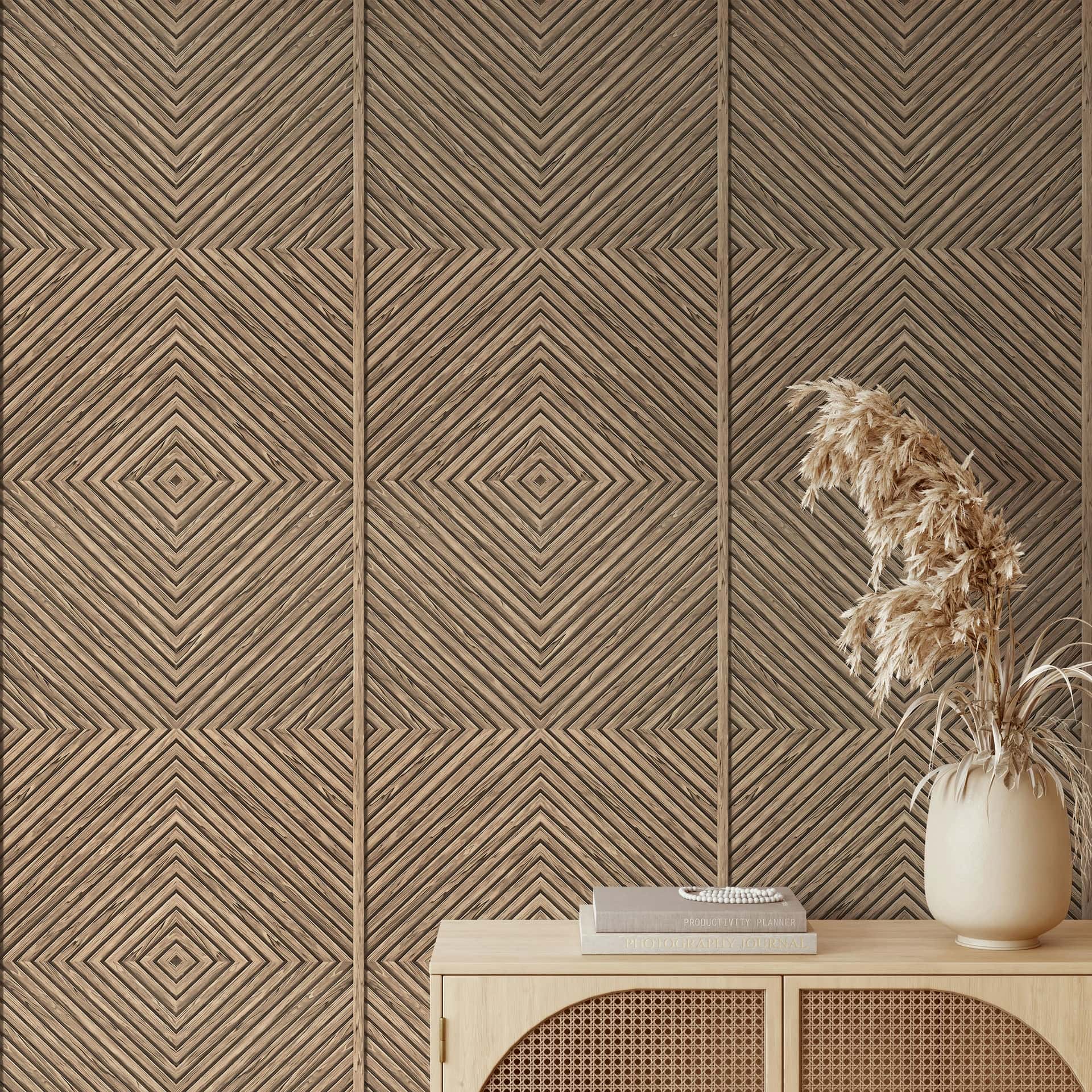 Marburg Naomi 89019 Beige geometric wallpaper with diagonal lines forming nested diamonds, shown behind a light wood console with stacked books and a ceramic vase of dried grasses.
