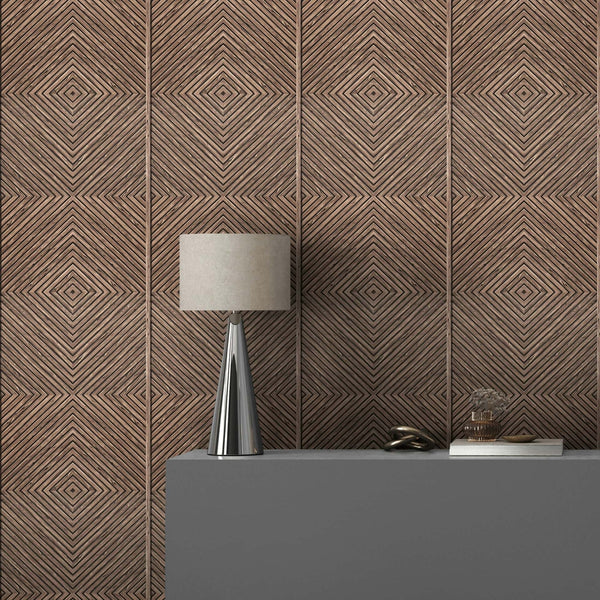 Marburg Naomi 89020 Brown wallpaper with a repeating concentric diamond pattern behind a grey console topped with a modern table lamp and small decor items.