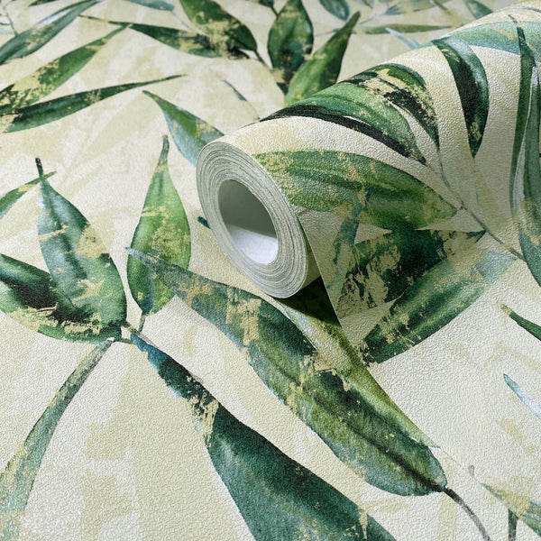 Marburg Naomi 89040 Close-up of a wallpaper roll resting on matching unrolled wallpaper with green leaves on a light background.
