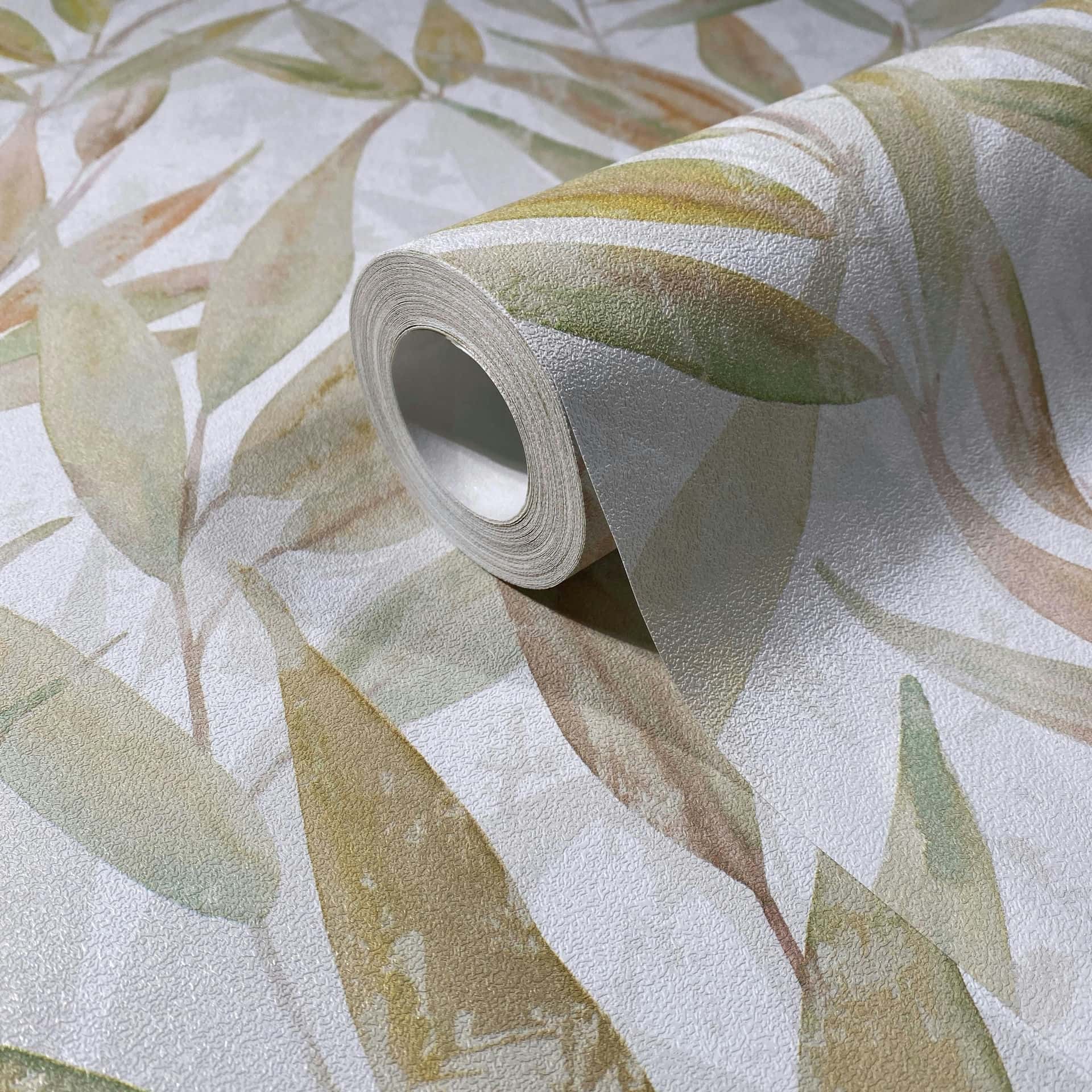 Marburg Naomi 89042 Watercolor-style botanical leaf pattern in soft green and yellow on a light textured background wallpaper roll showing its textured surface and finish.