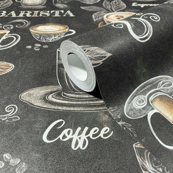 Marburg Naomi 89045 Close-up of a wallpaper roll resting on matching paper with a dark chalkboard look, showing hand-drawn coffee cups, beans, leaves, and the word “Coffee” with partial “Barista” text.