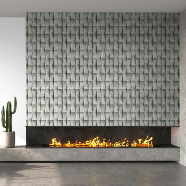 Marburg Novamur Mona 81651 Installed gray geometric 3D‑effect wallpaper shown as a feature panel above a long linear fireplace with visible flames; a potted cactus sits on the concrete hearth.