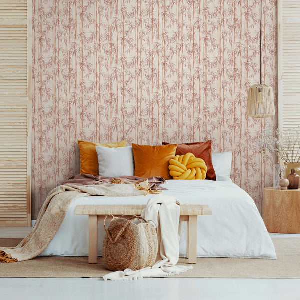 Marburg Novamur Mona 81670 Vertical bamboo stalks and leaves in a muted orange/terracotta print on a beige background wallpaper on a bedroom feature wall.
