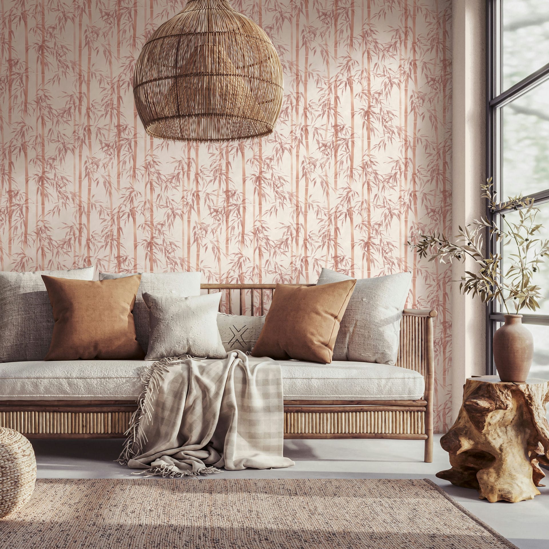 Marburg Novamur Mona 81670 Living room scene featuring bamboo-patterned wallpaper in warm orange on a light beige background. A wooden sofa with neutral pillows and a throw sits beneath a woven pendant; a stump side table with a ceramic vase and branches, a pouf, a textured rug, and a窓面.