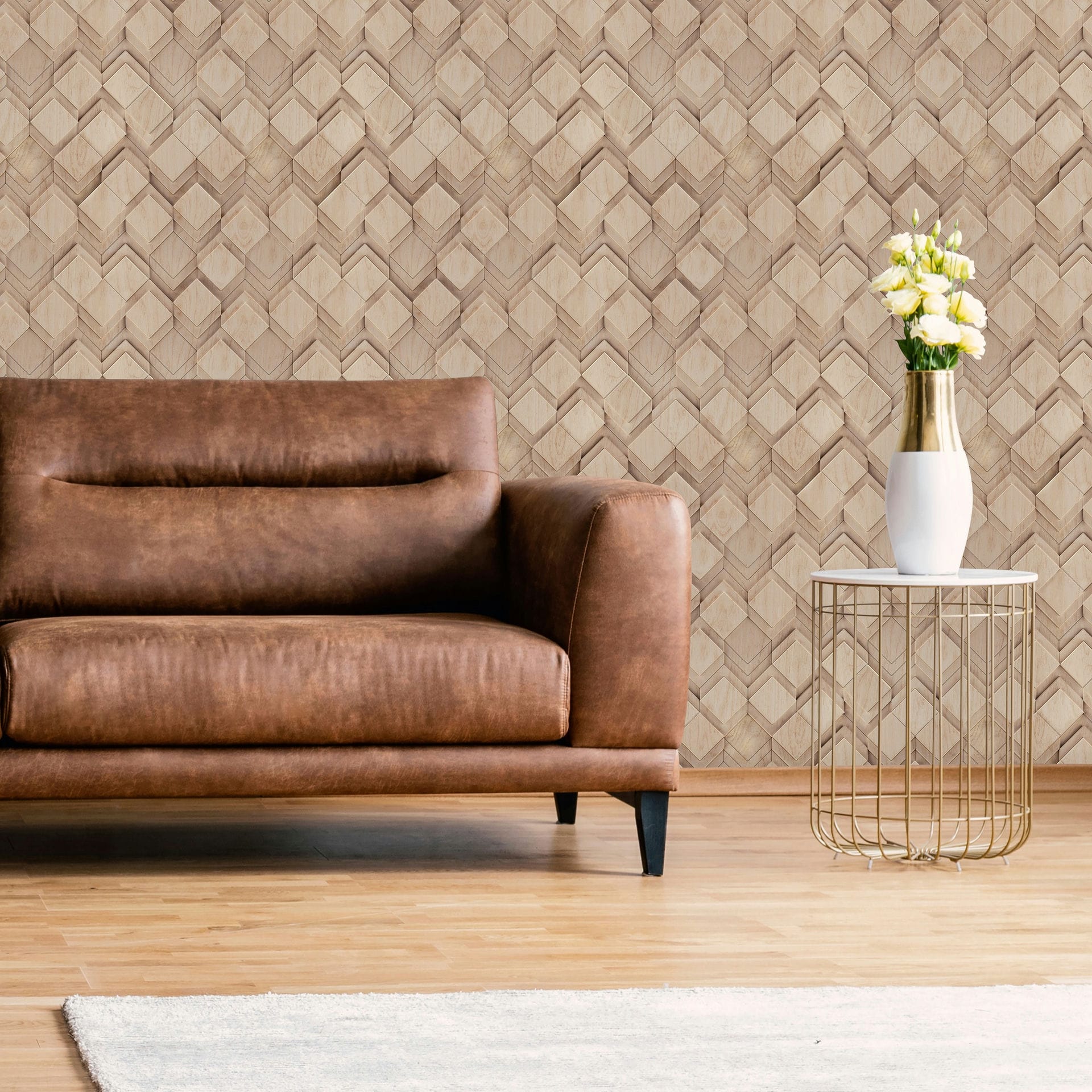 Marburg Novamur Mona 81675 Beige geometric woodgrain wallpaper behind a brown leather sofa and a round metal side table with a white vase of flowers.