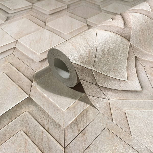 Marburg Novamur Mona 81677 Close-up of a wallpaper roll resting on matching unrolled wallpaper, showing a beige and light grey geometric pattern with beveled shapes that create a 3D effect.