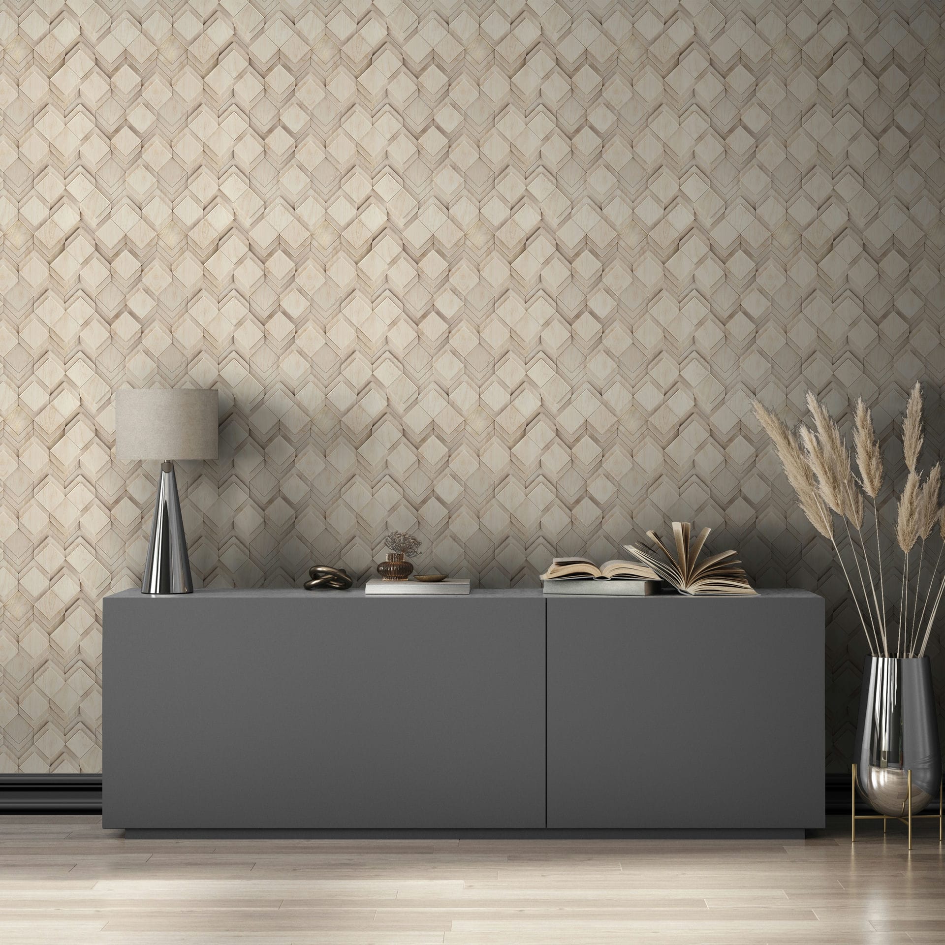 Marburg Novamur Mona 81677 Beige and grey geometric chevron wallpaper behind a gray sideboard with a table lamp, open books, and a tall vase of pampas grass.