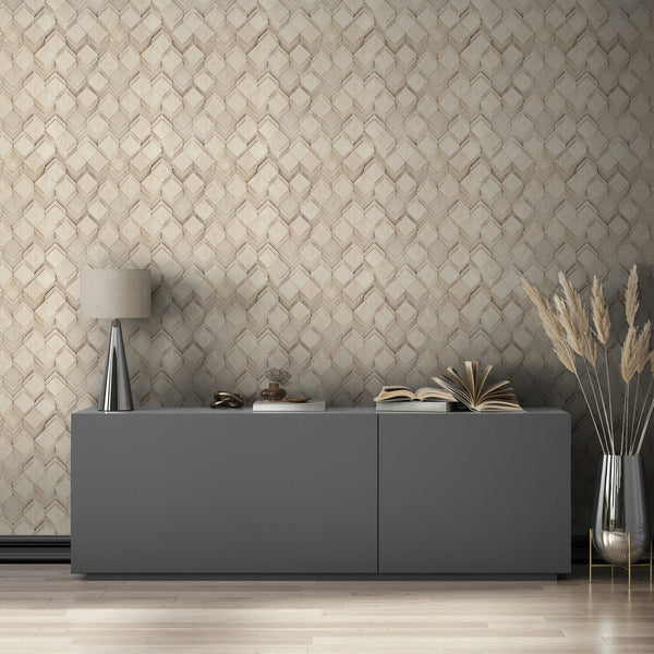 Marburg Novamur Mona 81677 Beige and grey geometric chevron wallpaper behind a gray sideboard with a table lamp, open books, and a tall vase of pampas grass.