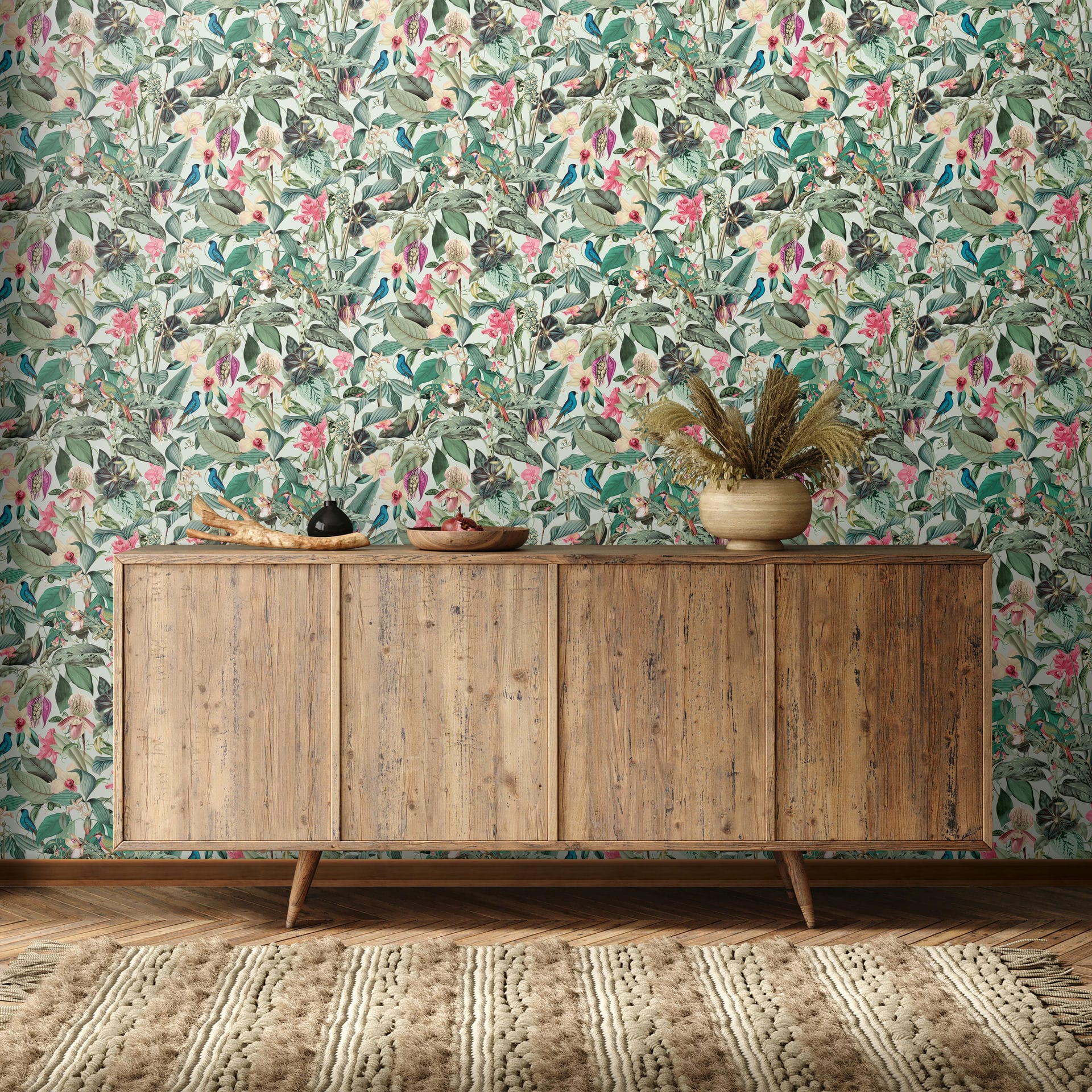 Marburg Novamur Mona 81684 Dense botanical print with green leaves, pink flowers, and small birds on a light background wallpaper on a living room feature wall.