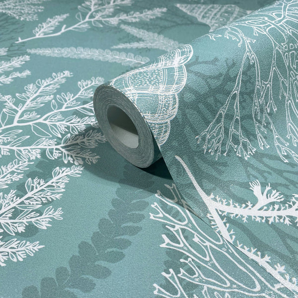 Marburg Novamur Mona 81688 Wallpaper roll on a matching surface, showing a green background with white seaweed-like branches and a shell motif on a lightly textured wallpaper.