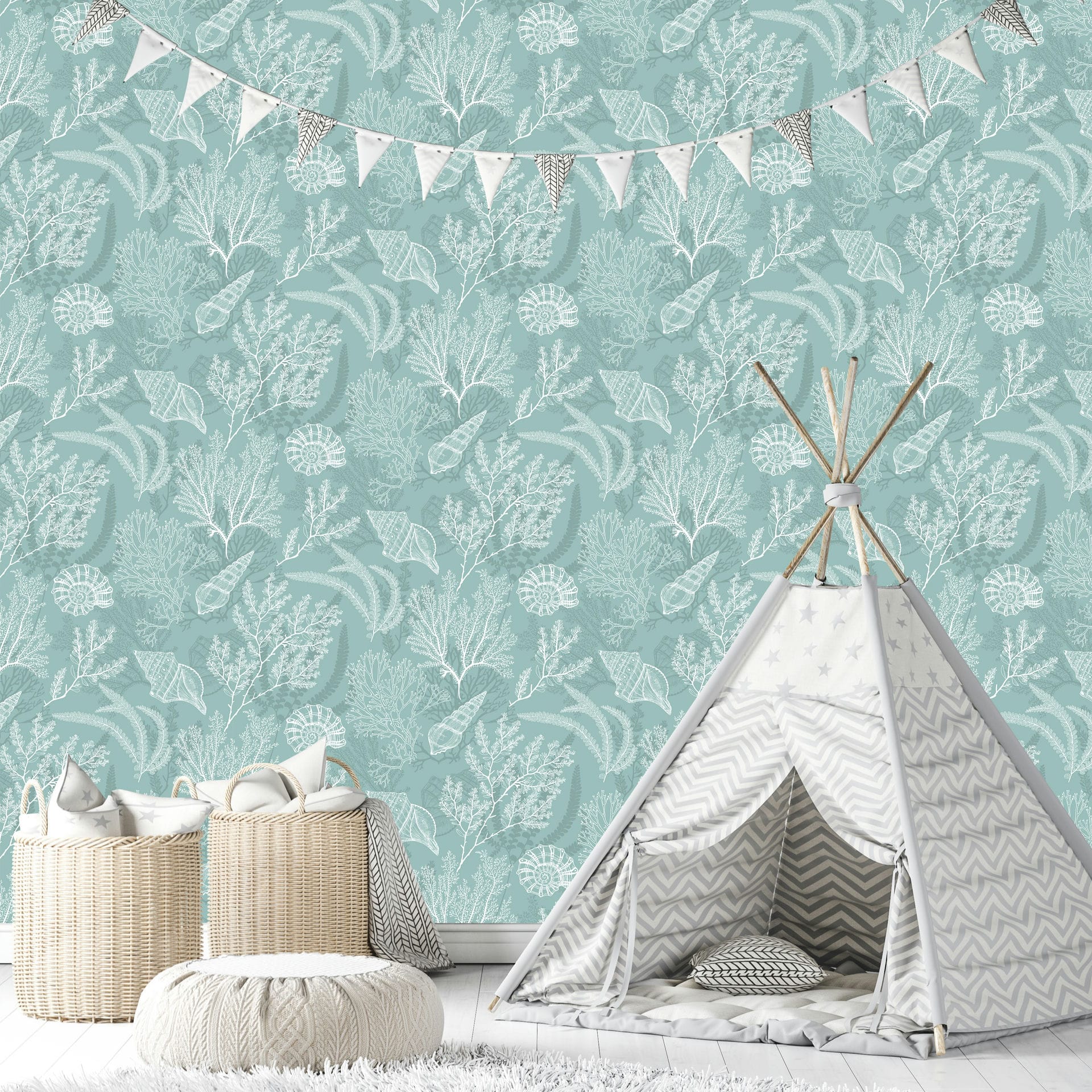 Marburg Novamur Mona 81688 Sea life wallpaper with white coral, shells, and seaweed on a green background, shown in a nursery with bunting, a play teepee, wicker baskets, and a knitted pouf.