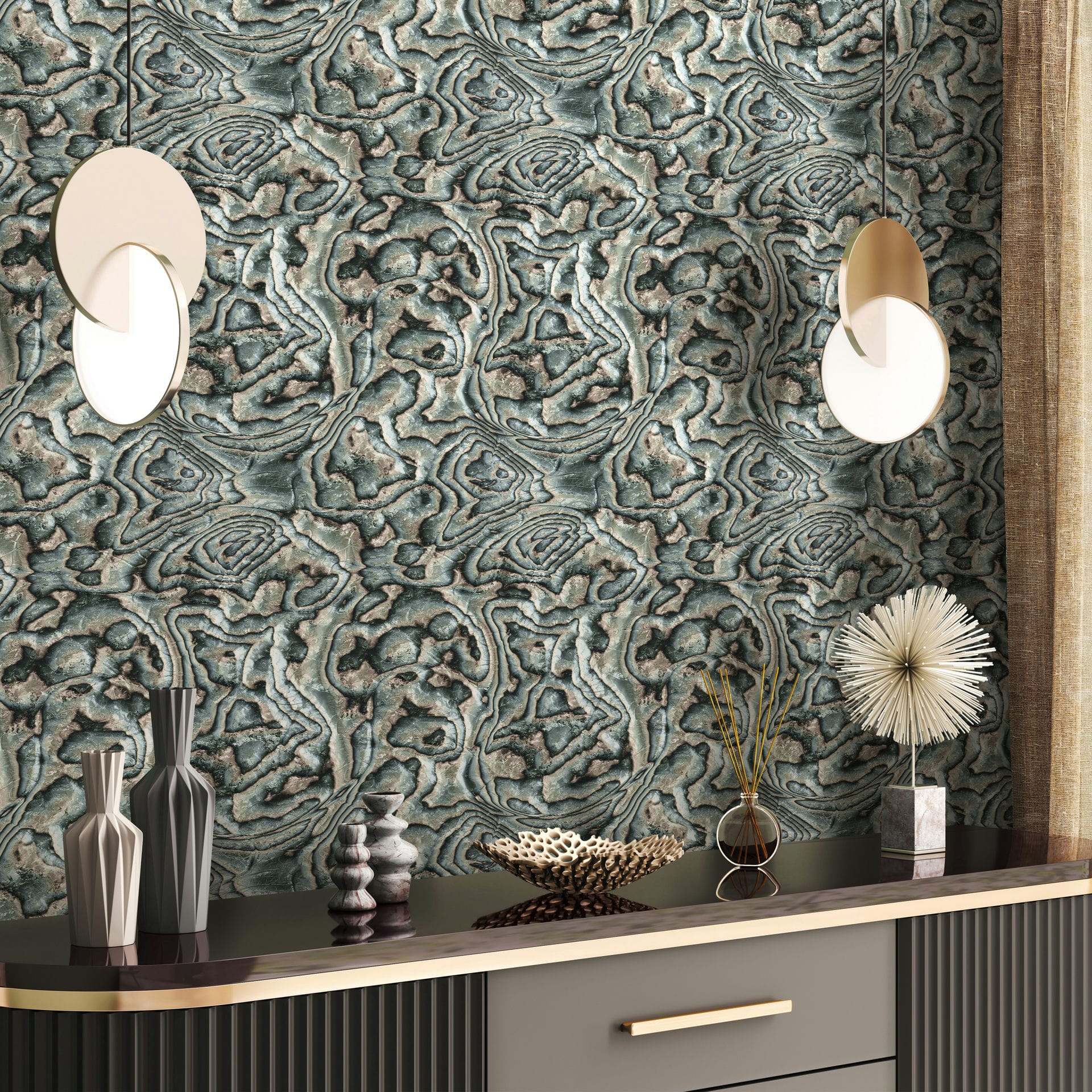 Marburg Novamur Mona 81691 Abstract stone-like wallpaper in beige, green, and grey behind a sideboard with a round pendant light, decorative vases, a bowl, a spiky sculpture on a block, a reed diffuser, and a curtain.