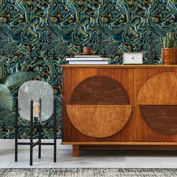 Marburg Novamur Mona 81693 Abstract geode-inspired wallpaper with organic swirls and veining in blue, green, and brown wallpaper on a living room feature wall.