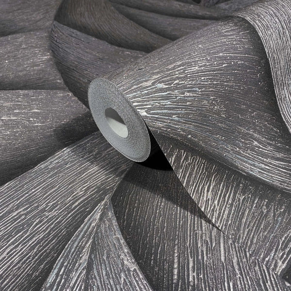 Marburg Ritus 35505 Close-up of a wallpaper roll resting on unrolled sheets, showing a dark ground with raised metallic striated texture.