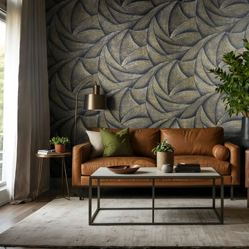 Marburg Ritus 35506 Living room with a caramel leather sofa in front of a bold black-and-gold swirling pattern wallpaper, with a coffee table, floor lamp, plants, and a window with curtains.