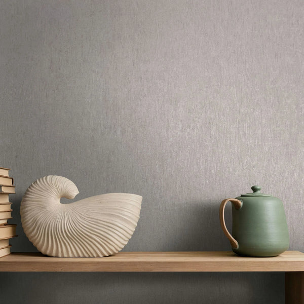 Marburg Ritus 35523 Gray textured wallpaper with fine vertical striations behind a wooden shelf holding stacked books, a shell-shaped ceramic piece, and a green teapot.